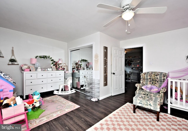 bedroom featuring a ceiling fan, a closet, dark wood finished floors, and baseboards