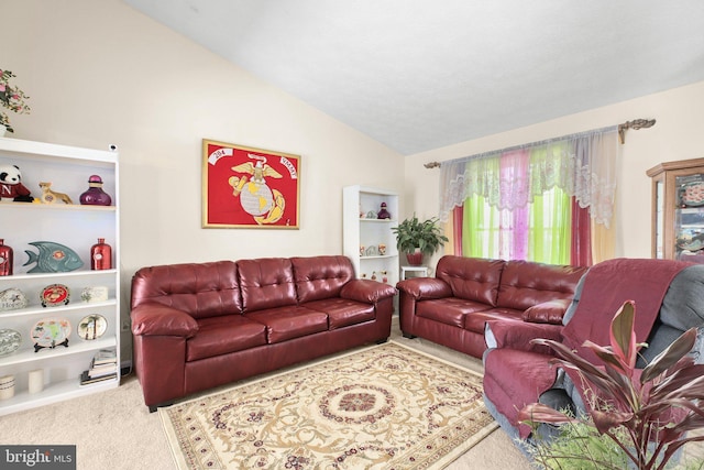 carpeted living room featuring vaulted ceiling