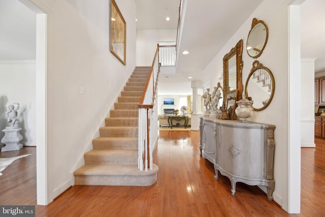 entryway featuring recessed lighting, light wood-style flooring, baseboards, and stairs