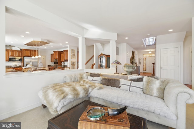 living room with recessed lighting, light carpet, and baseboards