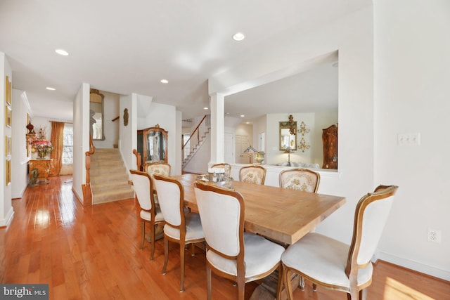 dining area with baseboards, stairway, recessed lighting, and light wood-style floors