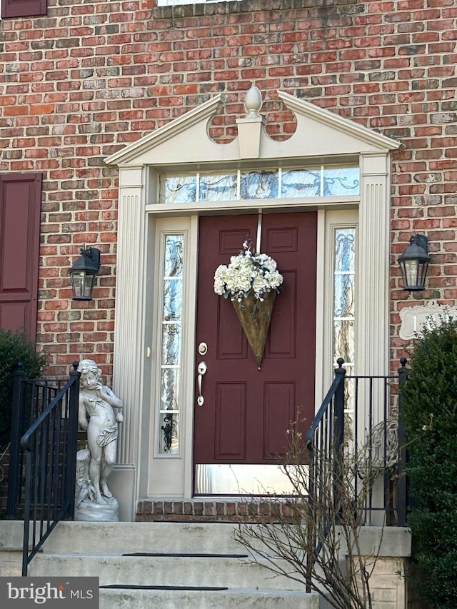 view of exterior entry with brick siding