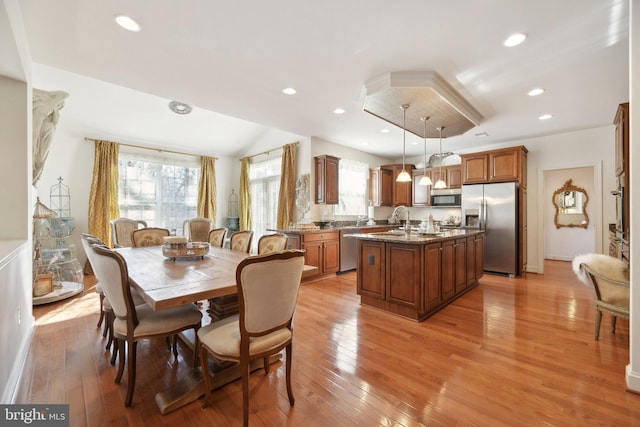 dining area with plenty of natural light, light wood-style flooring, and recessed lighting