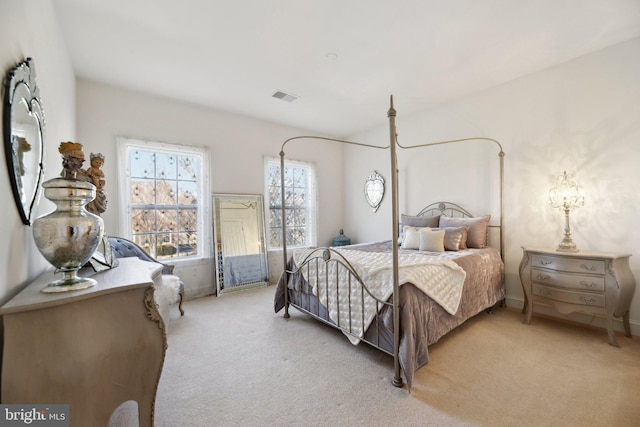 bedroom featuring light carpet and visible vents