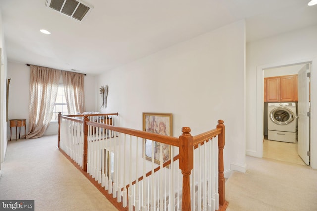 hallway with recessed lighting, light colored carpet, visible vents, an upstairs landing, and washer / dryer