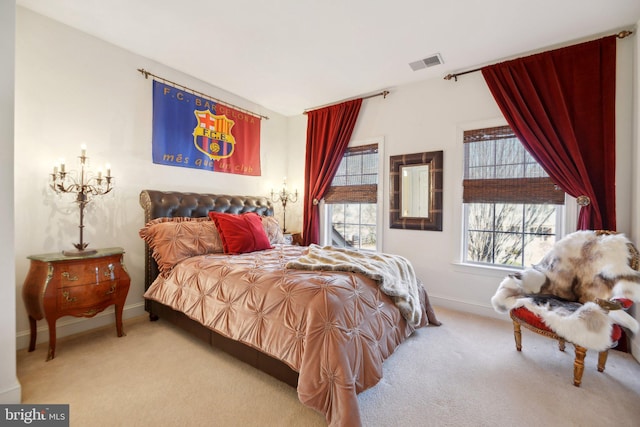 carpeted bedroom with visible vents and baseboards