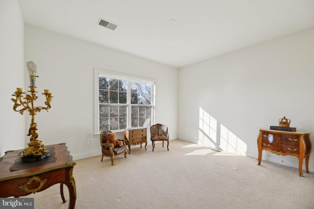 living area featuring light carpet, baseboards, and visible vents