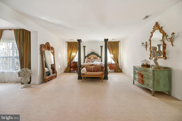 bedroom featuring baseboards, visible vents, and light colored carpet