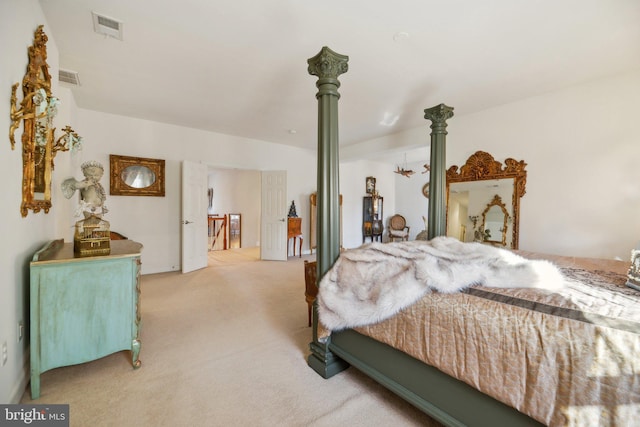 bedroom with light colored carpet and visible vents