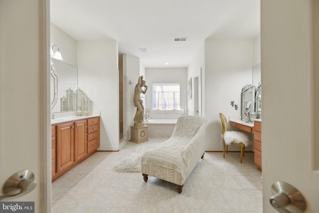 living area featuring visible vents and light tile patterned flooring