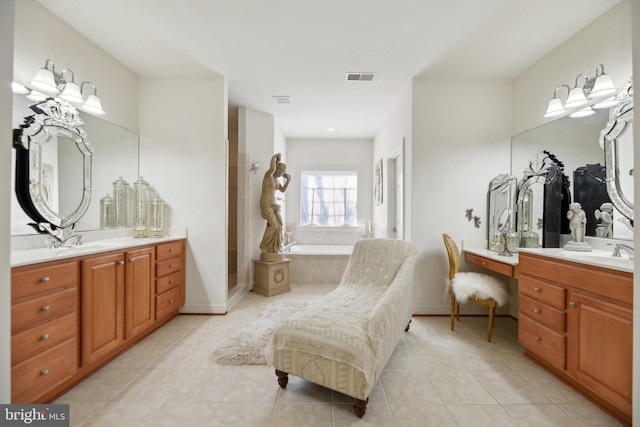 bathroom with visible vents, baseboards, vanity, a bath, and tile patterned floors