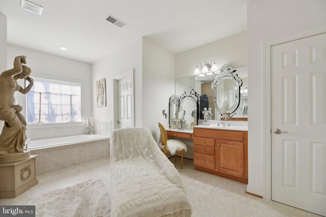 full bathroom with vanity, tile patterned flooring, a garden tub, and visible vents