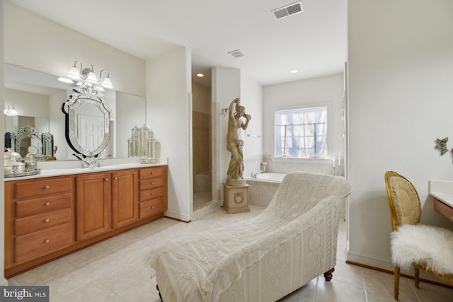 bathroom with visible vents, vanity, a bath, tiled shower, and tile patterned floors