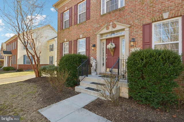 entrance to property with brick siding