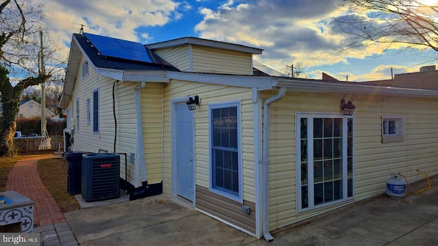 view of side of home featuring central air condition unit and a patio area