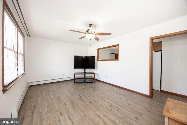 unfurnished living room featuring crown molding, a baseboard heating unit, baseboard heating, and light wood-style floors