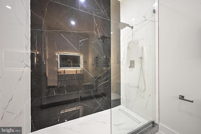 full bath featuring a marble finish shower