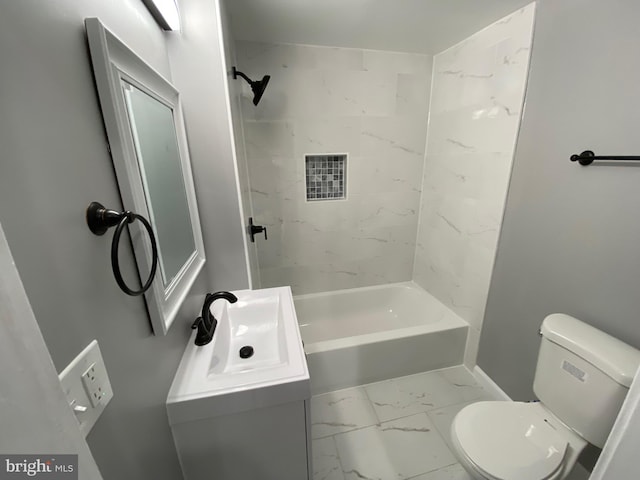 bathroom featuring toilet, marble finish floor, shower / bathing tub combination, and vanity