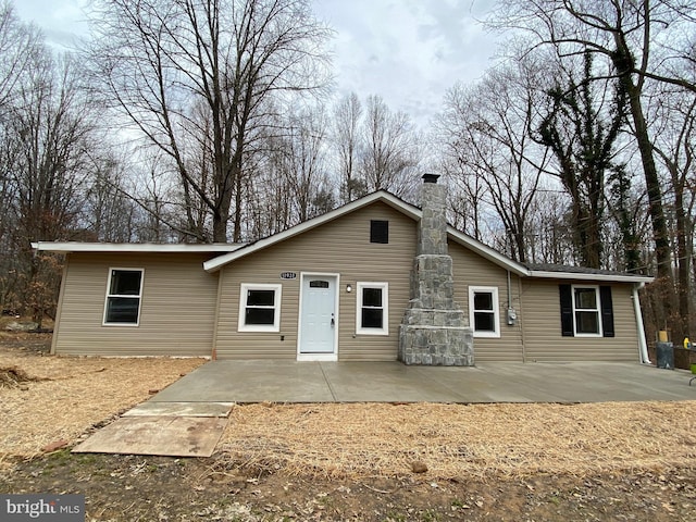 view of front of house with a chimney and a patio