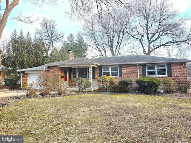 ranch-style home with an attached garage, a chimney, a front lawn, and brick siding