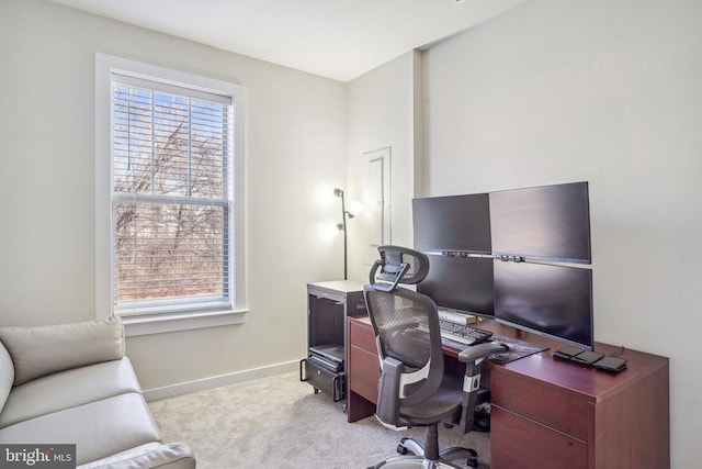 home office featuring light carpet and baseboards