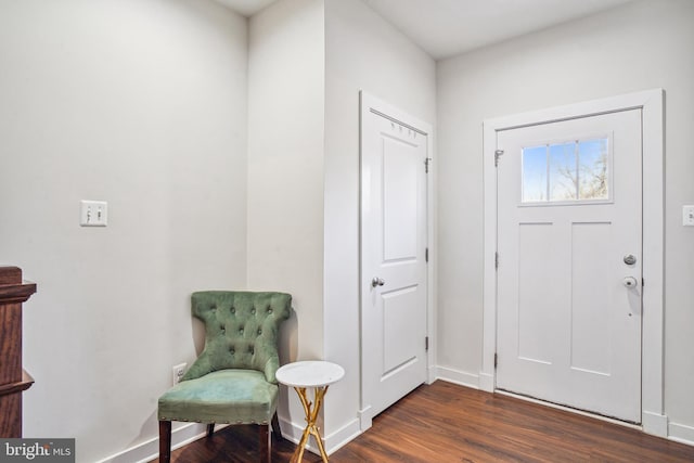 foyer entrance featuring dark wood-style flooring and baseboards