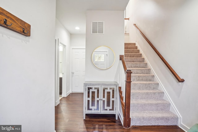 staircase featuring recessed lighting, visible vents, baseboards, and wood finished floors