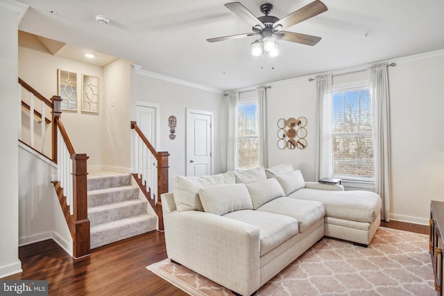 living area featuring ornamental molding, wood finished floors, baseboards, and stairs