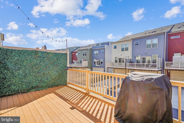 deck with grilling area and a residential view