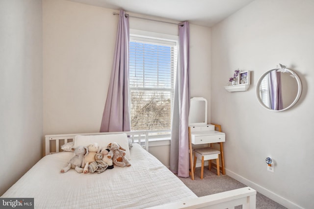 bedroom featuring baseboards and carpet flooring