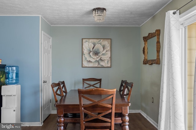 dining space featuring crown molding, a textured ceiling, and dark wood-style flooring