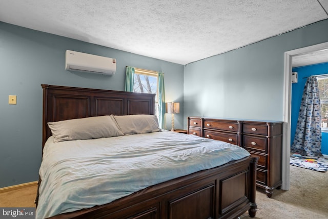 bedroom with light carpet, a textured ceiling, and an AC wall unit