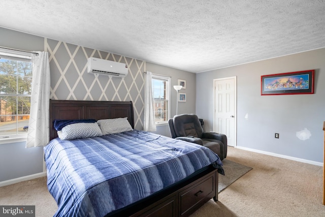 bedroom with wallpapered walls, a wall mounted AC, carpet flooring, and baseboards