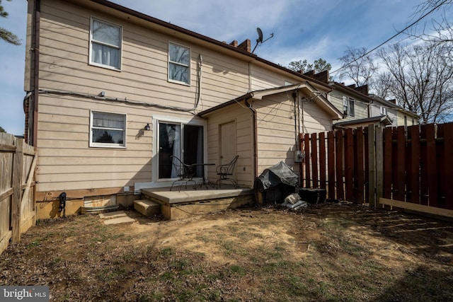 back of property featuring a fenced backyard