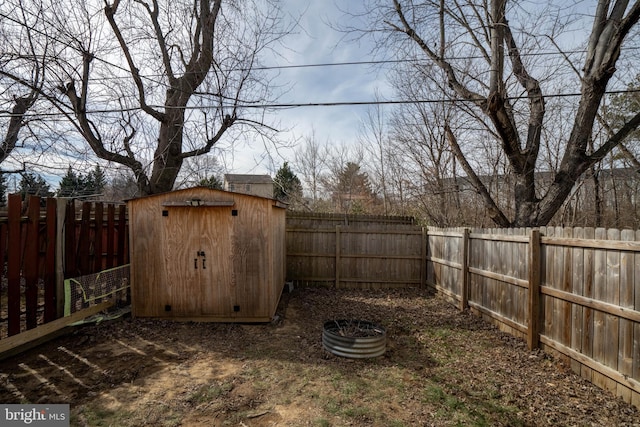 view of yard with an outbuilding, a shed, and a fenced backyard