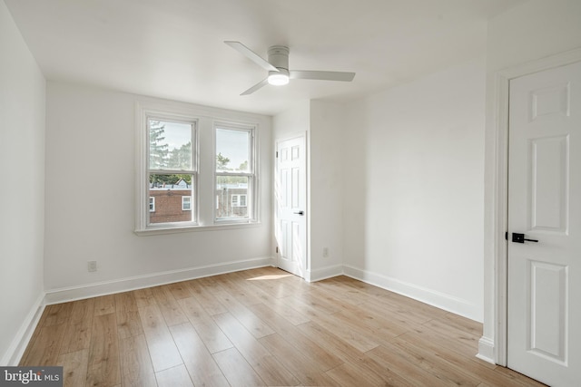 unfurnished room featuring baseboards, ceiling fan, and light wood finished floors