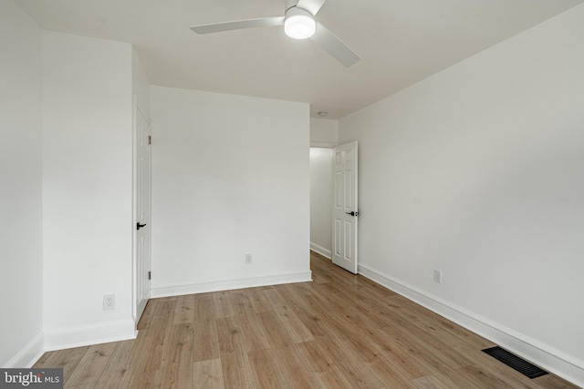 unfurnished bedroom featuring a ceiling fan, light wood-style flooring, visible vents, and baseboards