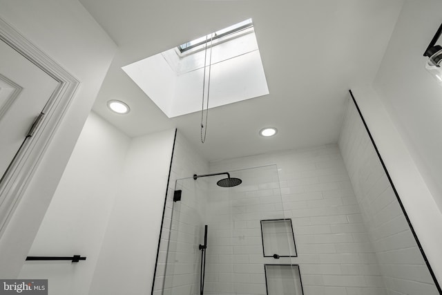 full bathroom featuring a skylight, a shower stall, and recessed lighting