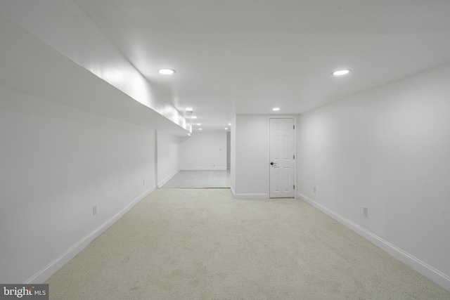 finished below grade area with recessed lighting, light carpet, and baseboards