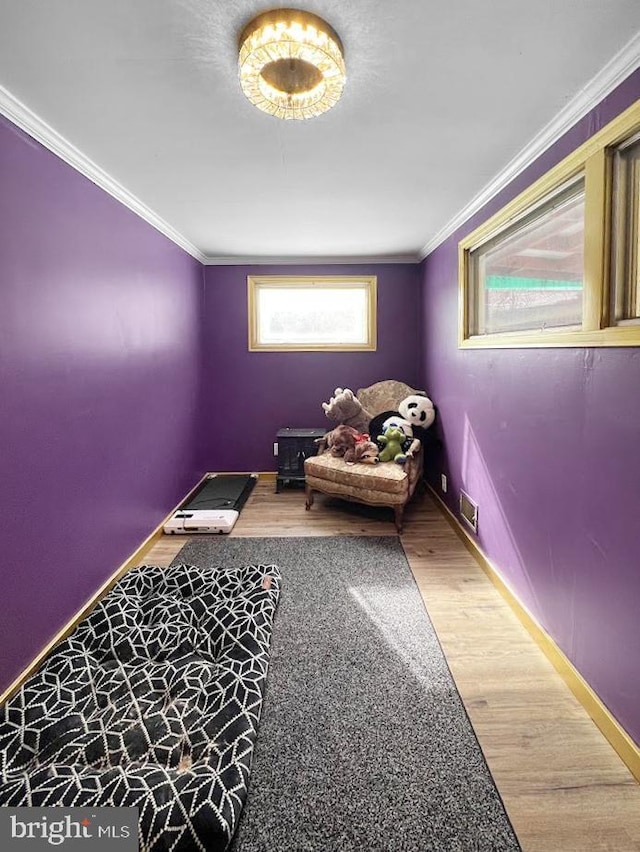 unfurnished room featuring visible vents, crown molding, baseboards, and wood finished floors