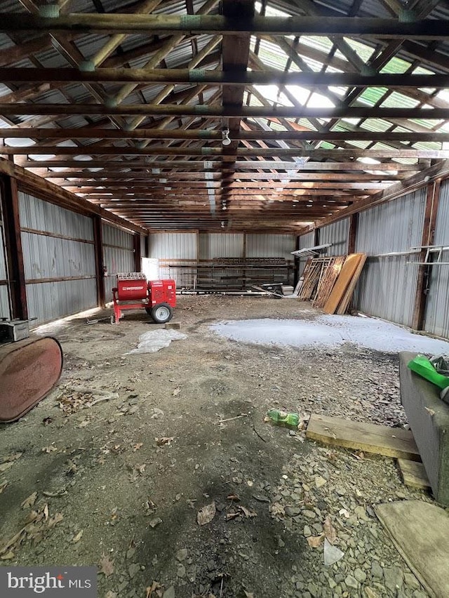 misc room with lofted ceiling and metal wall