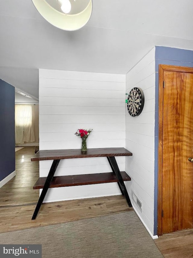 interior space featuring baseboards and wood finished floors