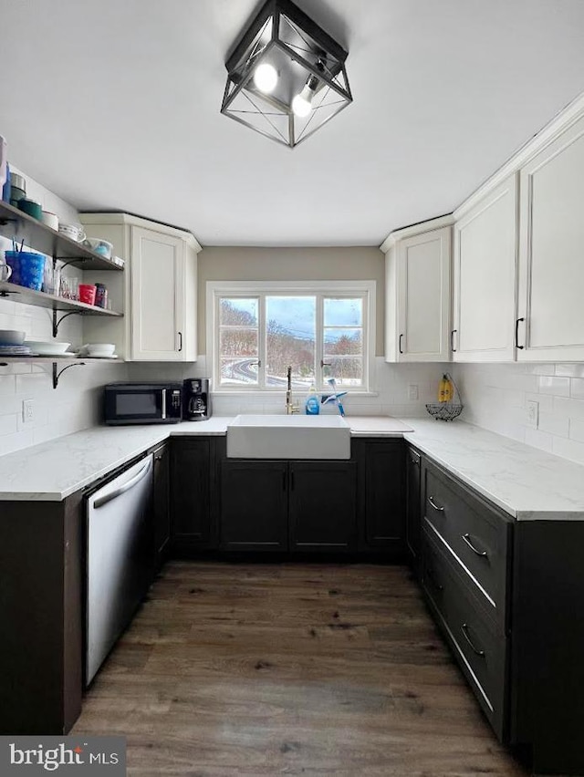 kitchen featuring a sink, light stone counters, white cabinets, and dishwasher