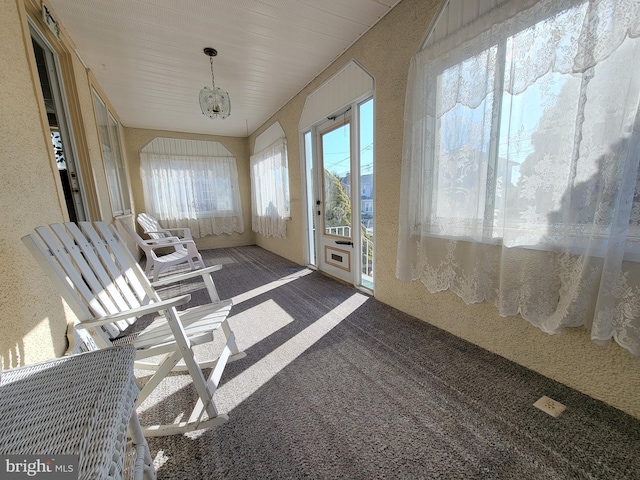 unfurnished sunroom featuring an inviting chandelier