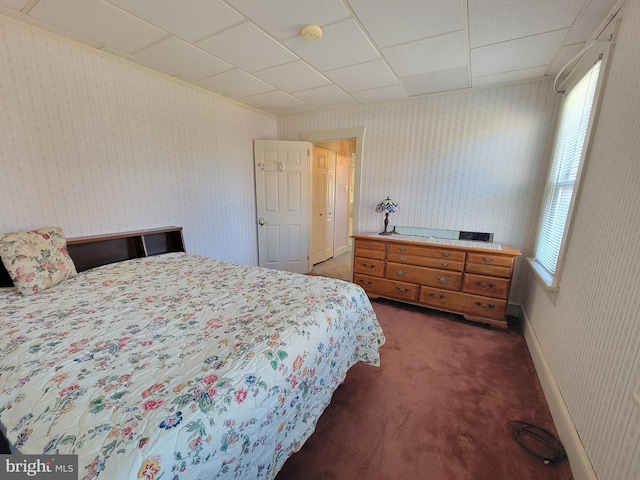 bedroom with carpet floors, baseboards, and wallpapered walls