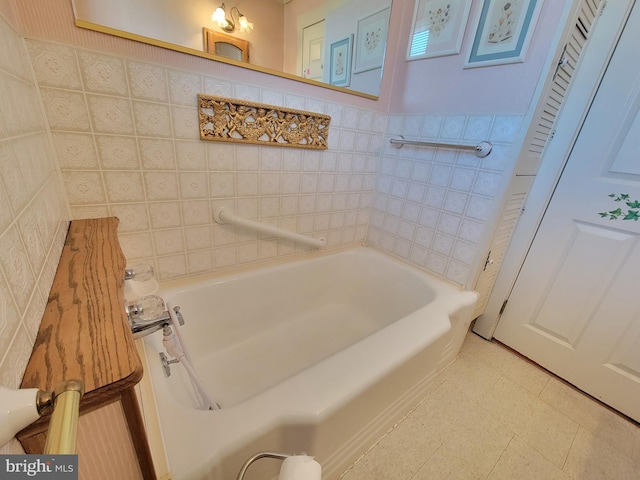 bathroom featuring a tub to relax in and tile walls