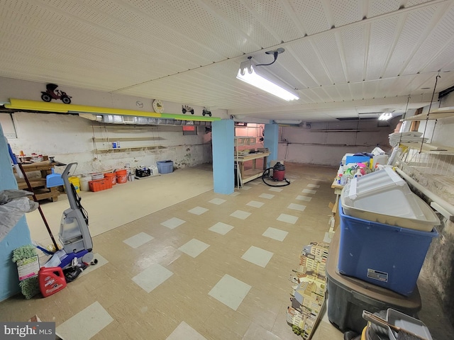 below grade area with a garage and tile patterned floors