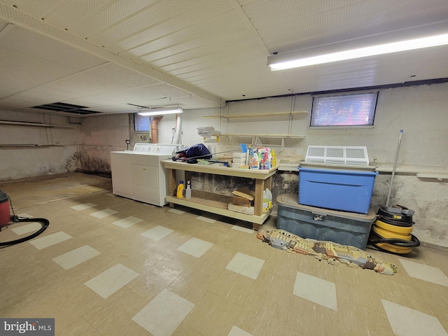 finished basement with washing machine and clothes dryer and tile patterned floors