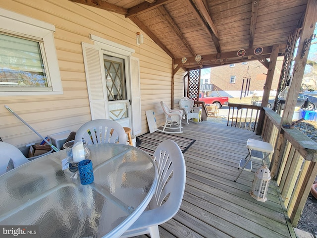 deck featuring covered porch and outdoor dining space