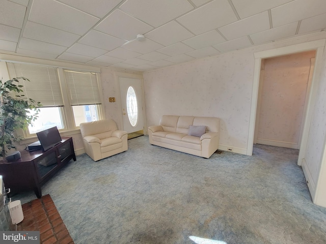 living area featuring carpet and baseboards